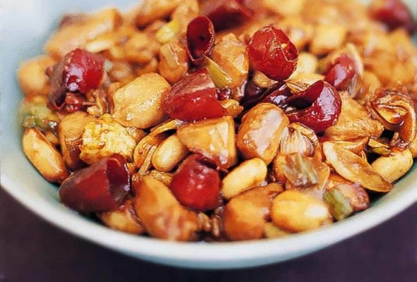 Bowl of chicken pieces, peanuts, chiles in an Authentic Chinese sauce of soy, sesame oil, black vinegar