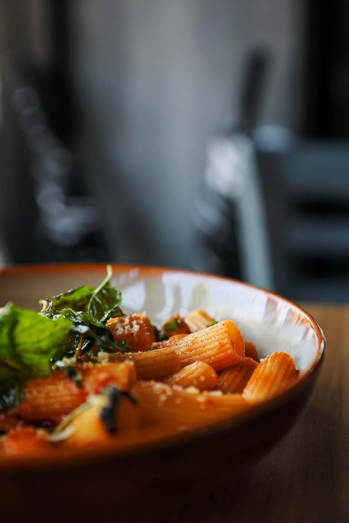A skillet filled with rigatoni with tomatoes, eggplant, and mozzarella.