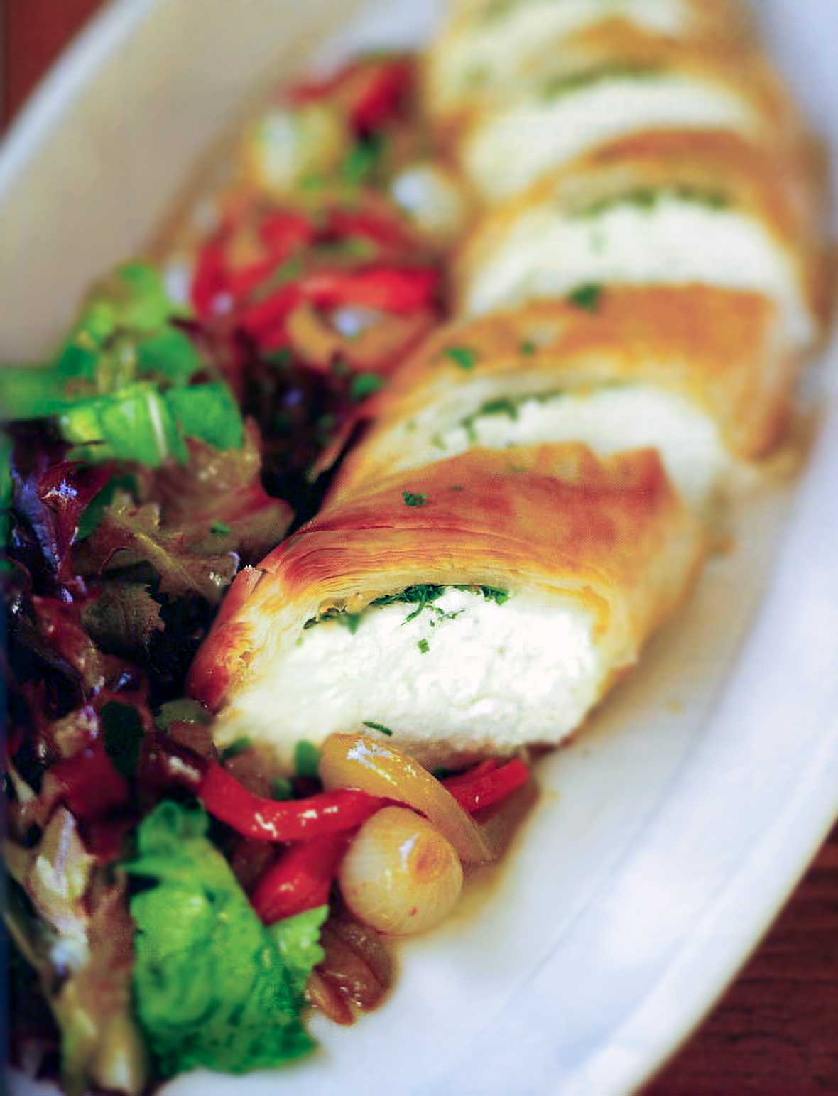 Goat cheese and herbs wrapped in a phyllo pastry log along side a red pepper salad