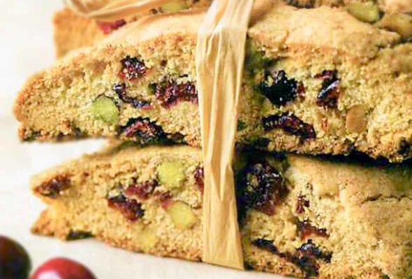 Several cranberry pistachio biscotti cookies tied together with raffia