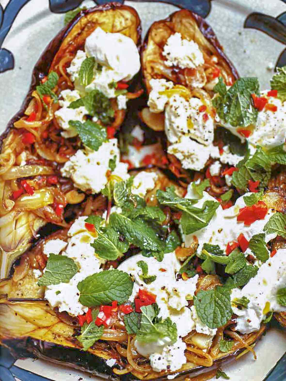 Baked eggplant topped with chiles, feta cheese and mint