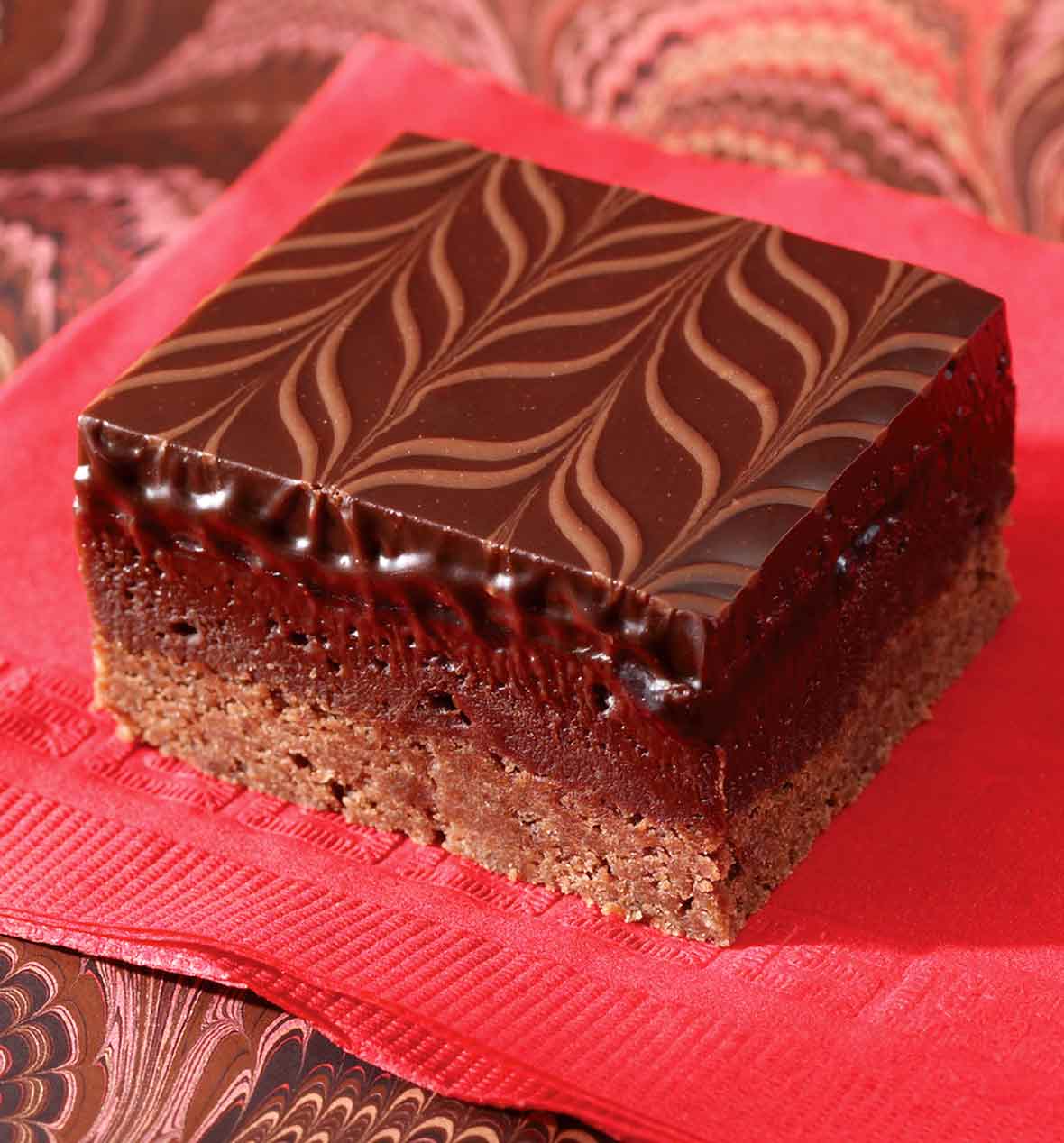A raspberry-truffle brownie bar--layers of cocoa shortbread, raspberry brownie, and chocolate ganache swirled on top