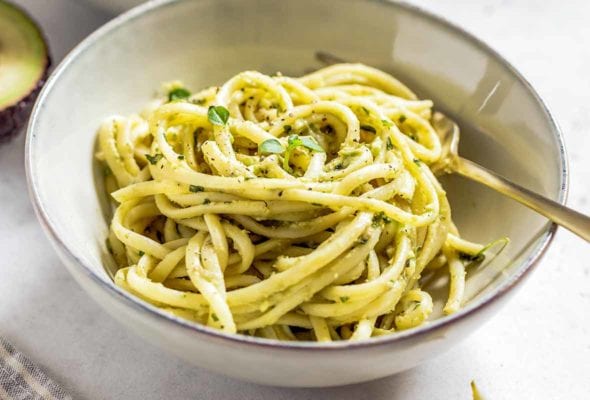 Two bowls of angel hair pasta with lemon cream sauce.