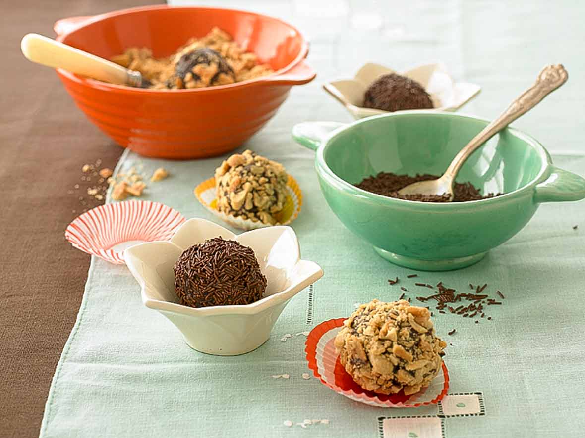 Chocolate truffle covered in crushed pretzels, a chocolate bonbon covered in chocolate sprinkles