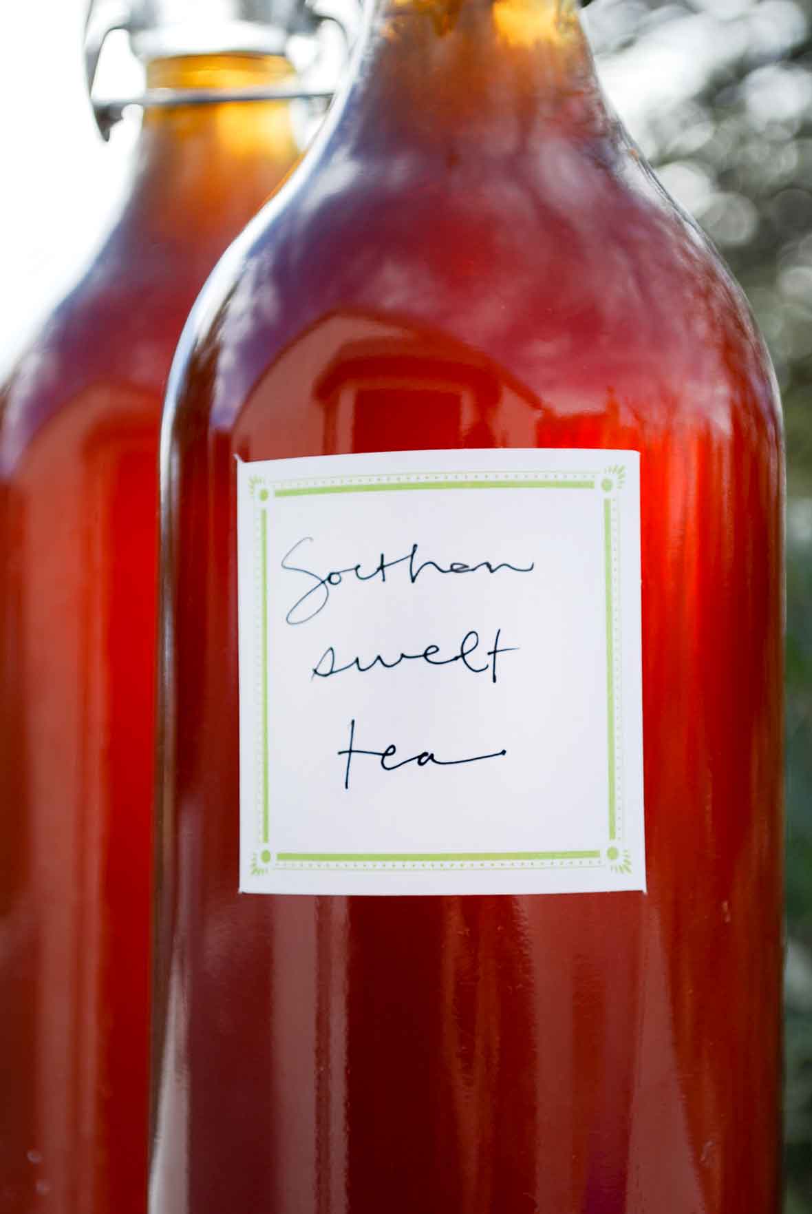 Two large glass bottles filled with Southern sweet tea.