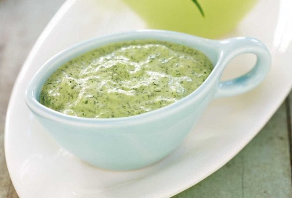 A light-blue gravy boat filled with svelte green goddess dip
