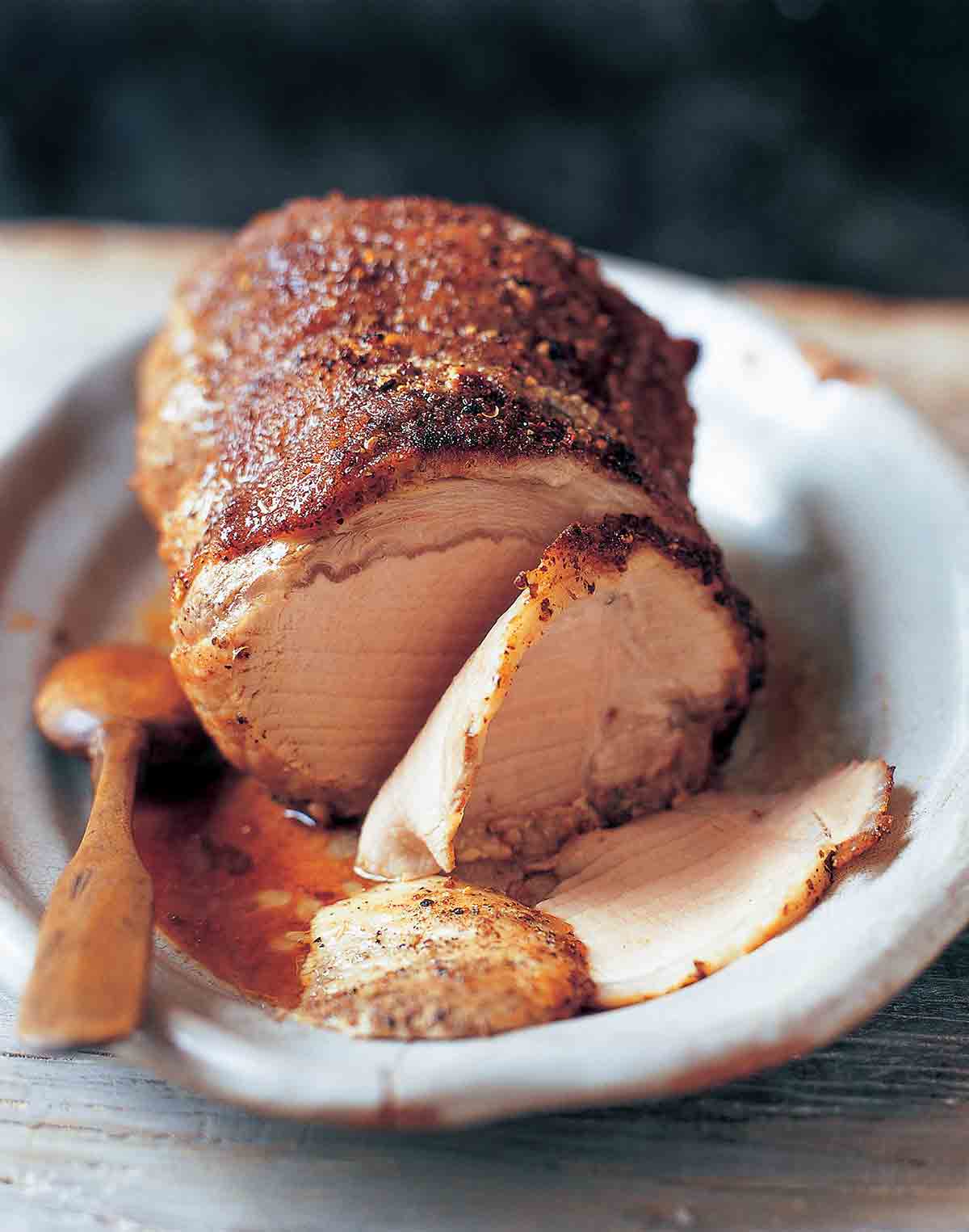 Szechuan spice-rubbed pork loin covered with ground Szechuan peppercorns, condiments on the side