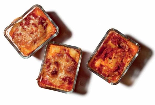 Three personal pan lasagnas in glass dishes.