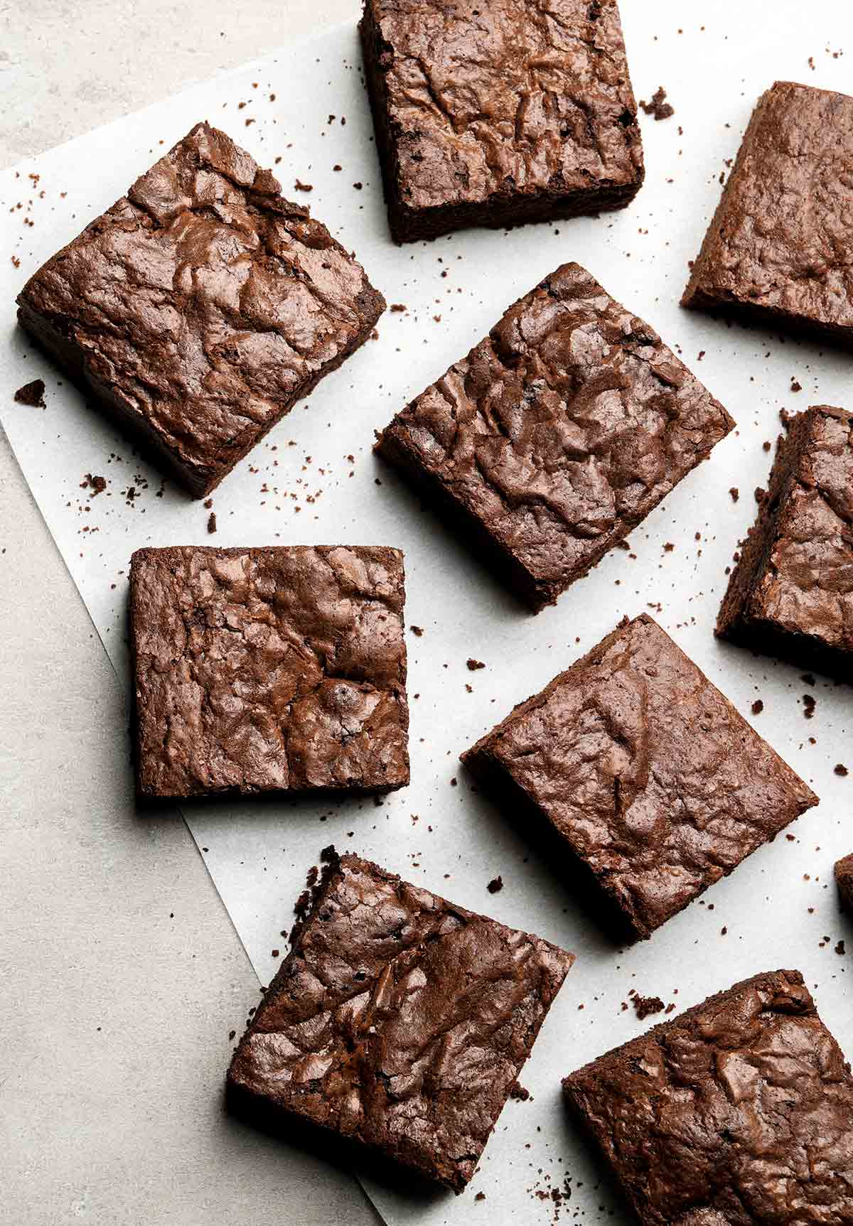 Squares of care-package brownies on parchment paper