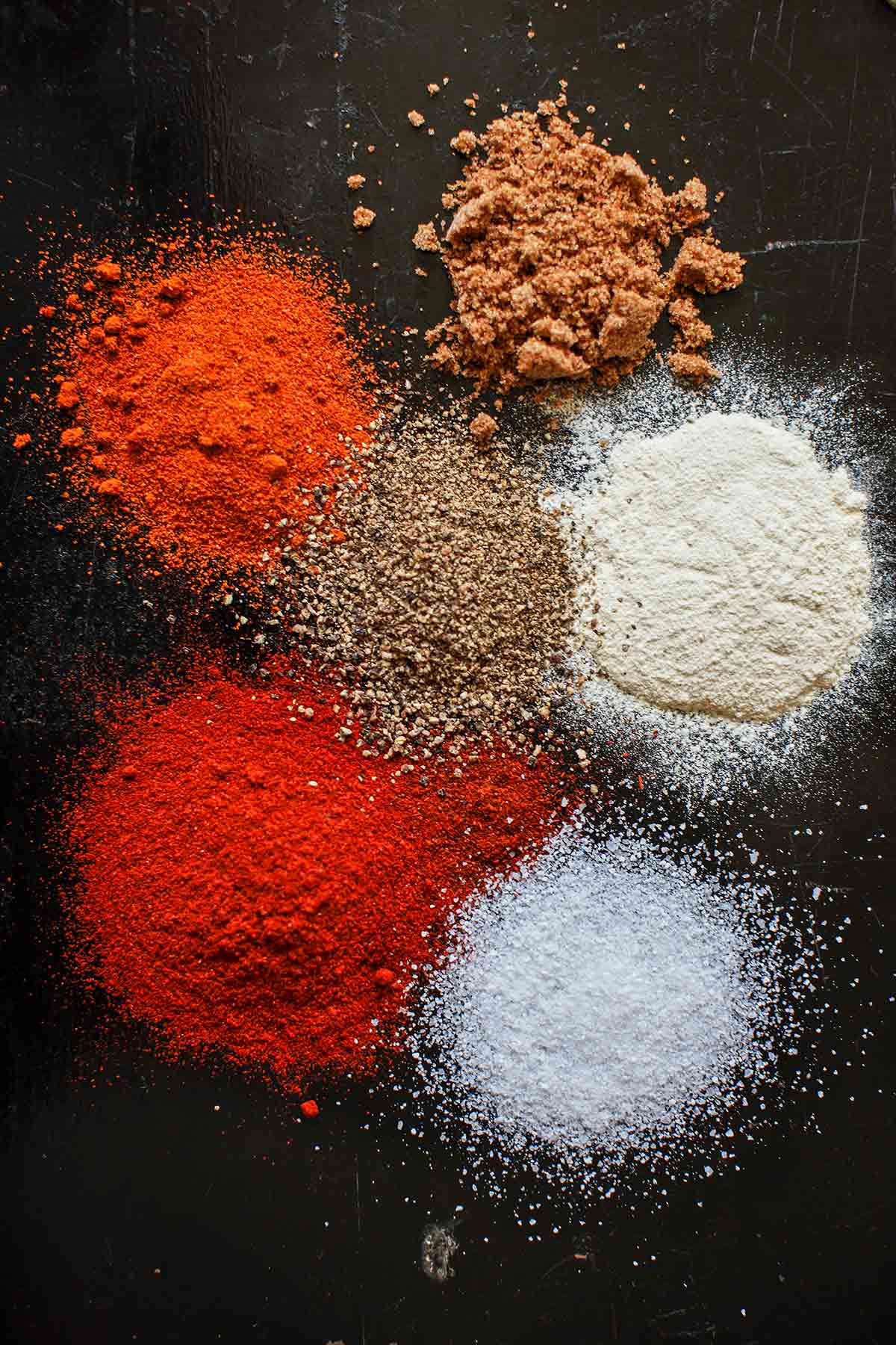 Small piles of the individual spices that make up Quito's barbecue butt rub.