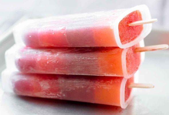 Three striped juice pops stacked on top of each other.