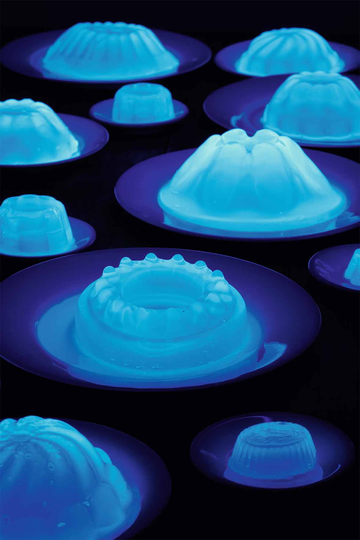 Several plates with fluorescent glowing Jello molds