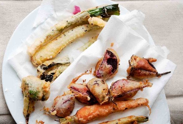 Vegetable tempura of zucchini, beets, carrots, squash on a paper towel on a plate