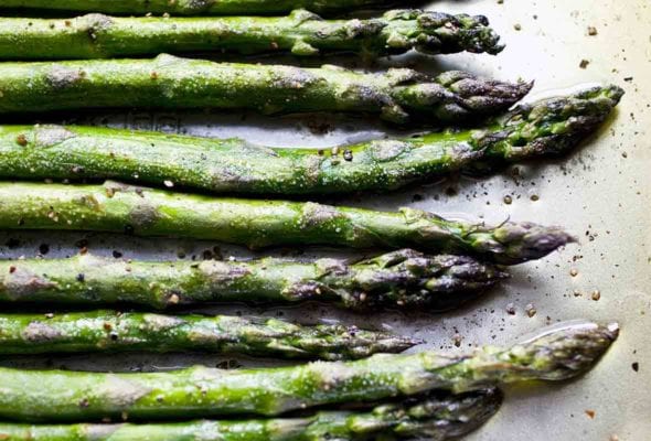 Roasted asparagus on a baking sheet.