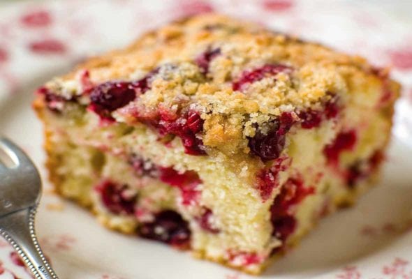 A square of cranberry buckle with a streusel top and studded with cranberries.