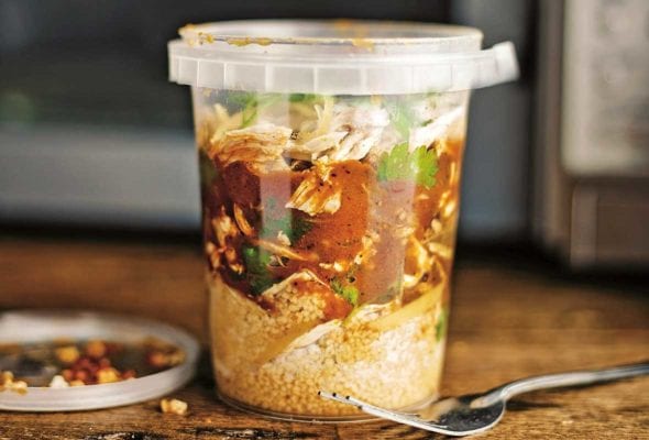 Plastic container or North African chicken soup with shredded chicken, ras el hanout, couscous, and preserved lemon