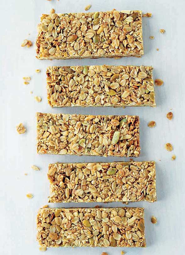 Five cinnamon granola bars on a white background.