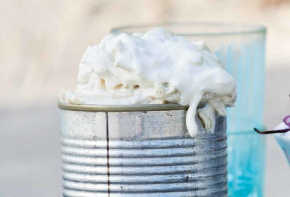 A tin can filled with fennel slaw--a type of coleslaw-on a metal tray