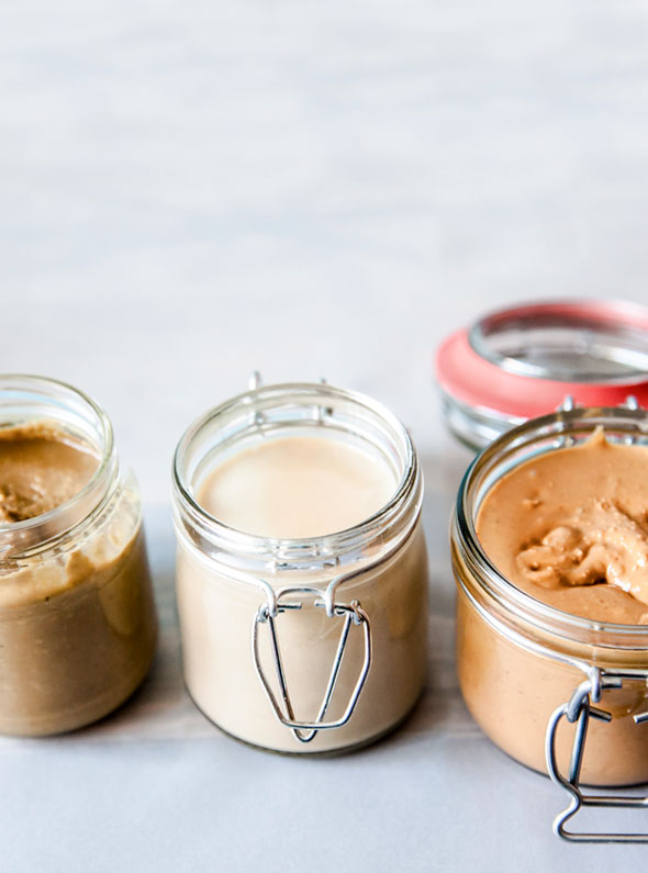 Three jars of different types of homemade nut butter.