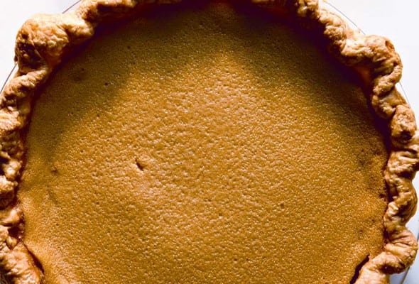A whole cooked maple buttermilk pie in a glass pie dish.