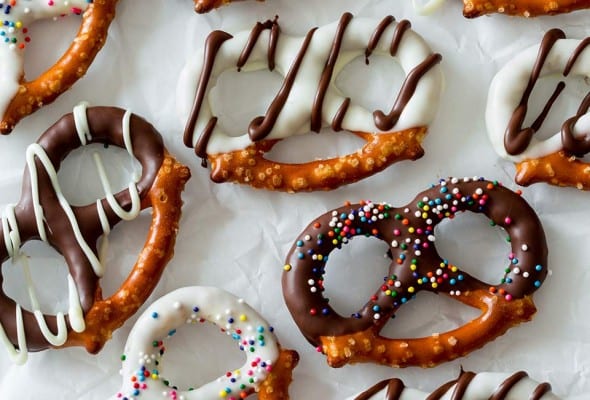An assortment of chocolate covered pretzels with white and dark chocolate coating and sprinkles