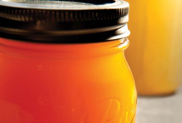 A few Mason jars filled with chicken bone broth.