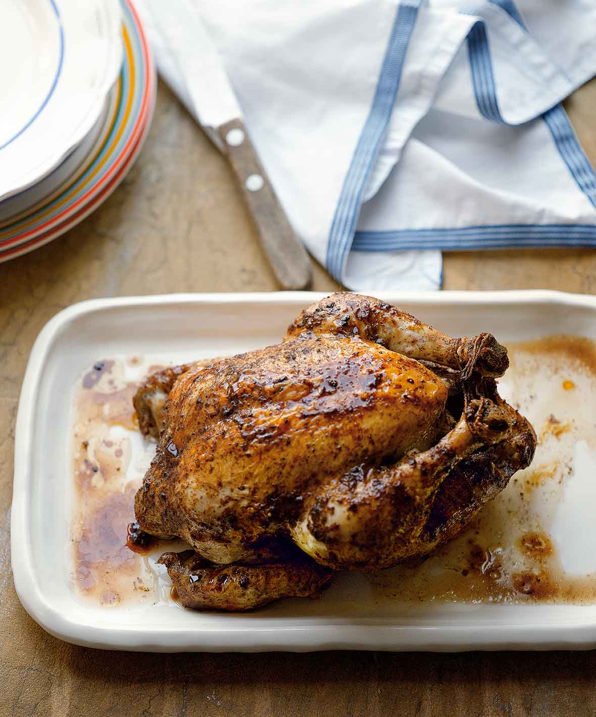 A whole Chinese roast chicken on a white tray.