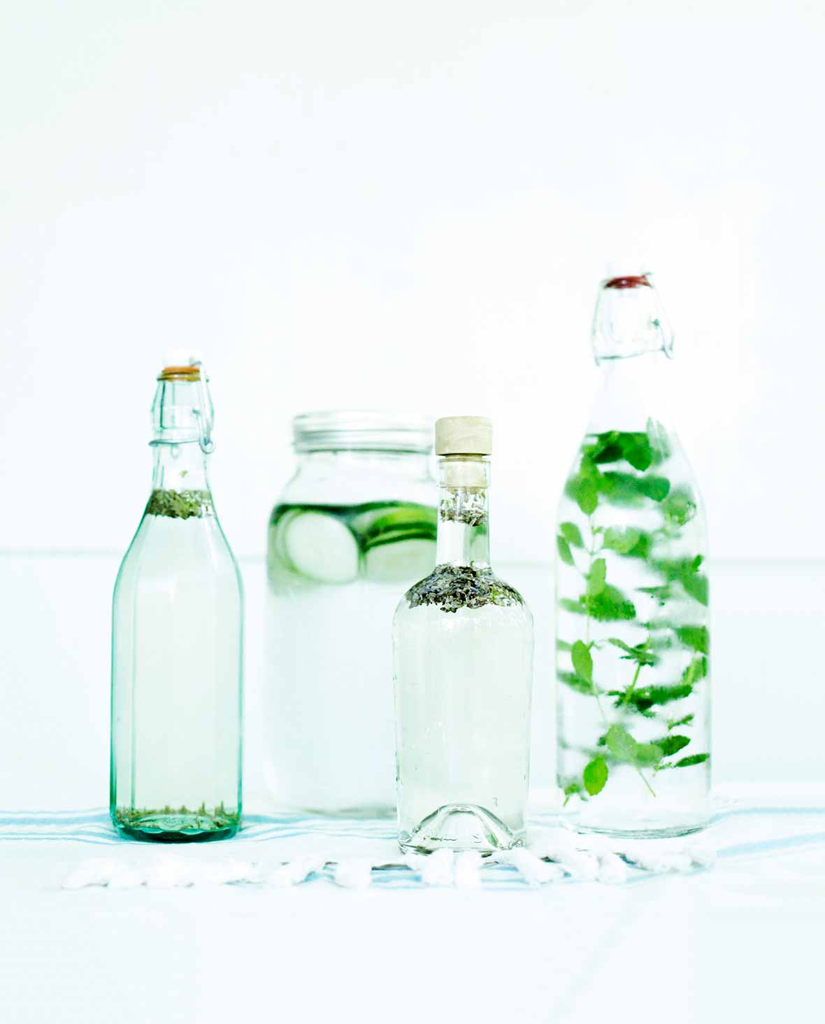 Four bottles of infused water prepared using the instructions on how to infuse water.