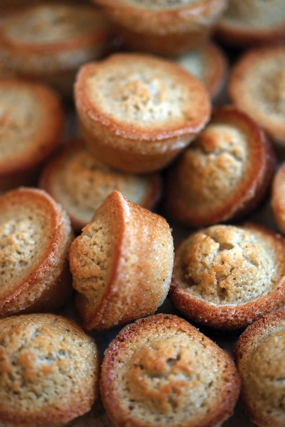 A pile of brown butter financiers baked in mini muffin molds