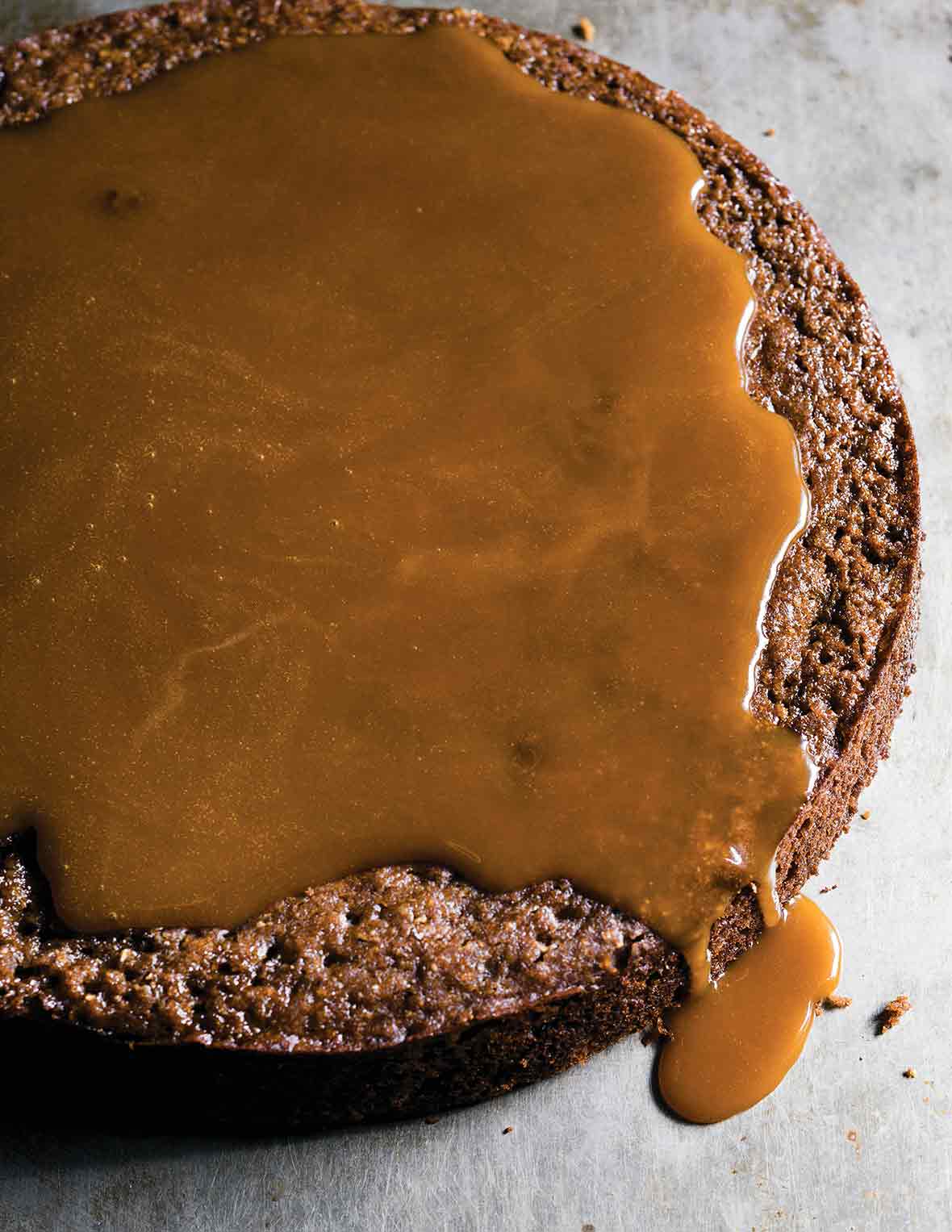 A round cake covered in toffee sauce