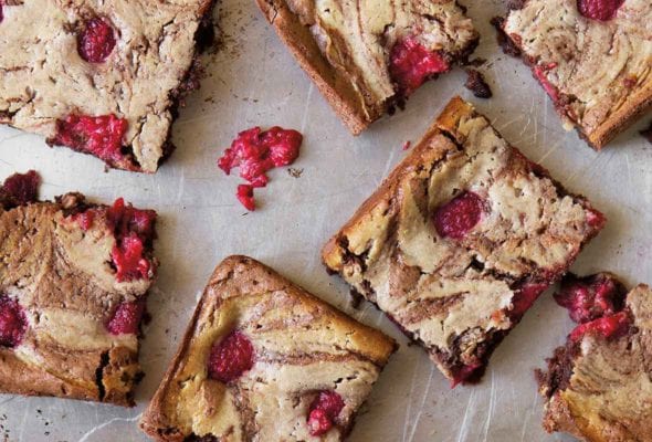 Squares of raspberry cheesecake brownies.