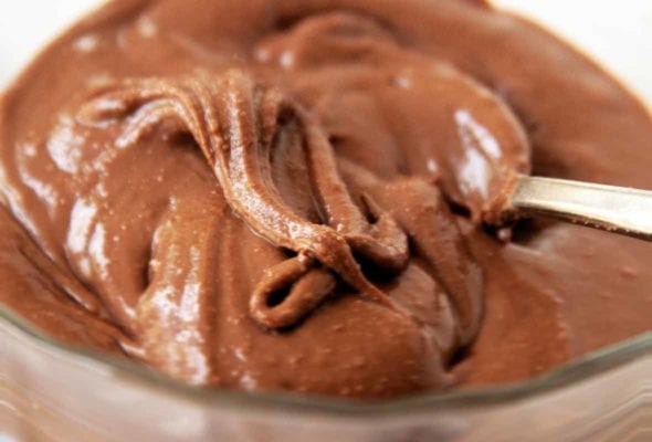 A bowl of homemade nutella with a spoon resting in it