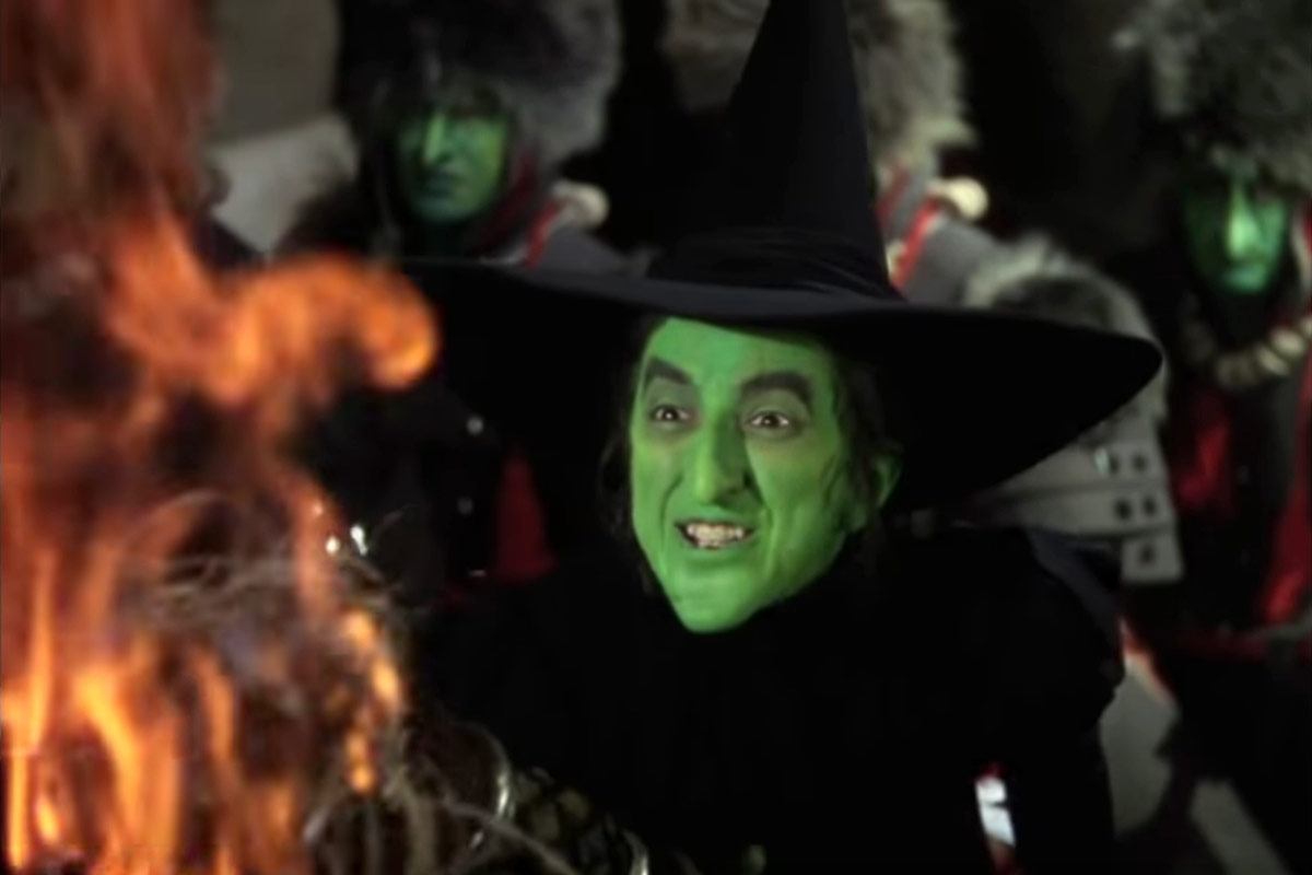 The wicked witch of the west by a fire.