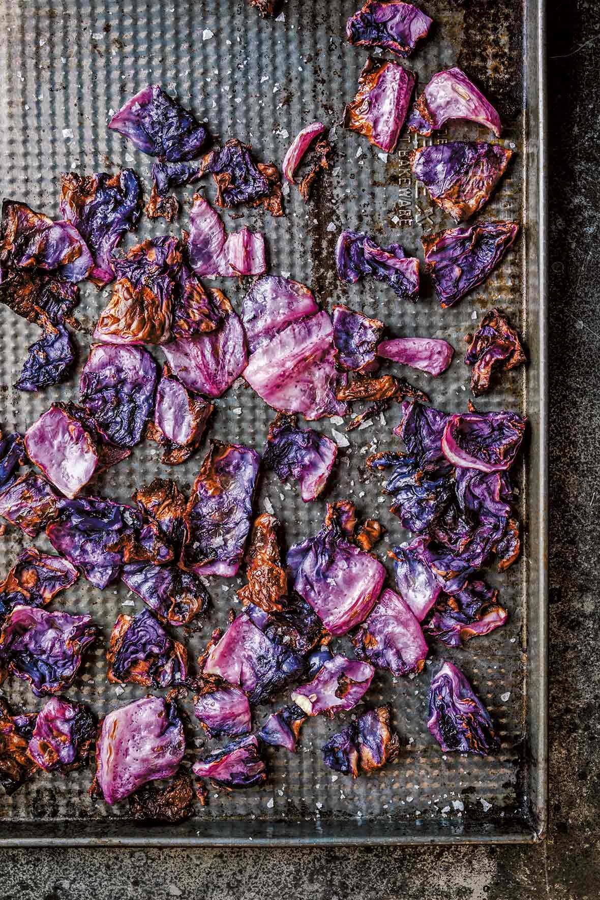 Roasted red cabbage on a cooling rack set in a baking sheet