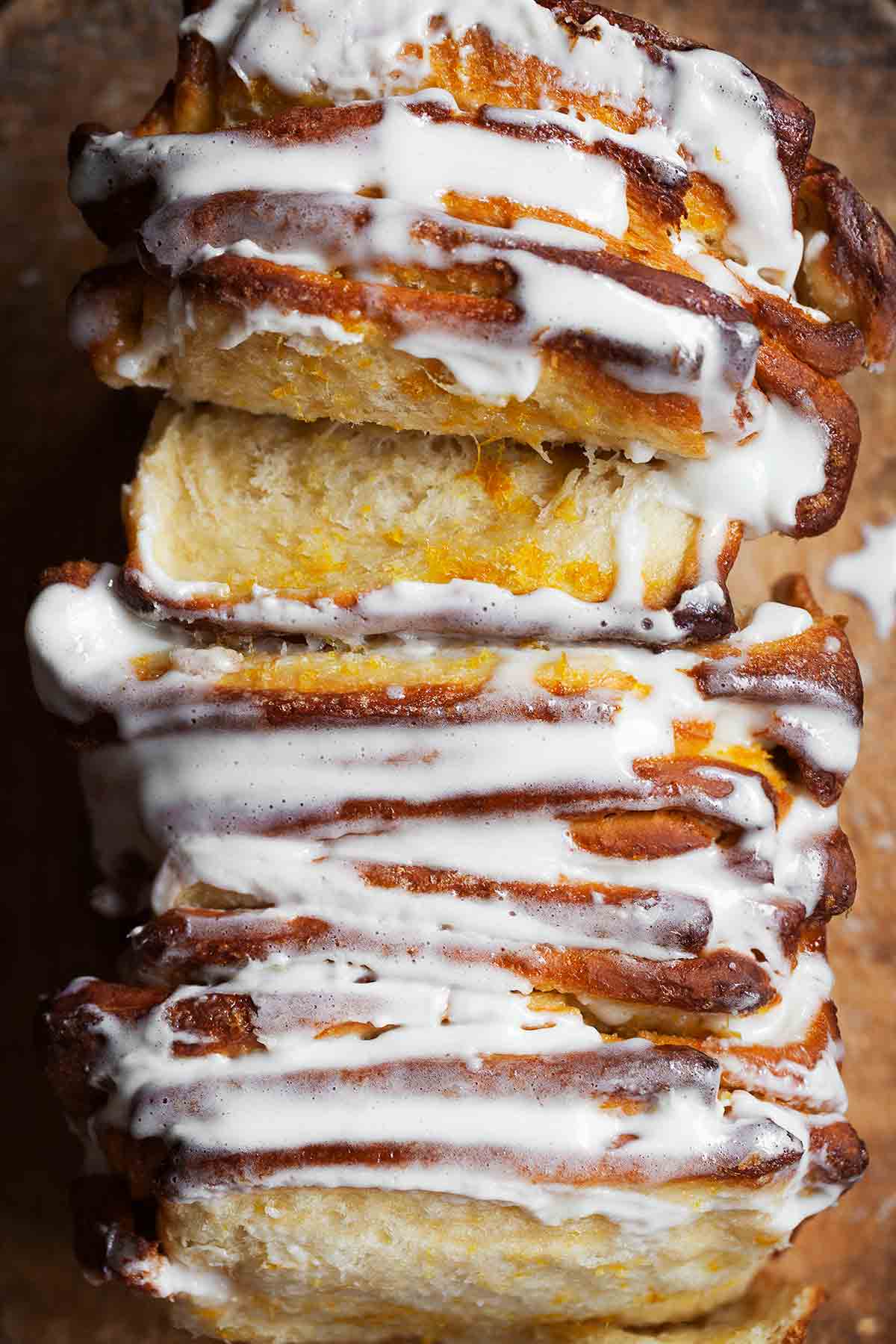 A glazed lemon pull-apart coffee cake pulled apart in a few places.