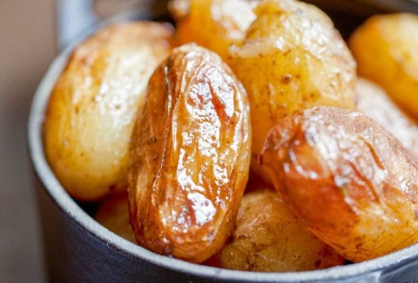 Cast iron pot with braised new potatoes inside