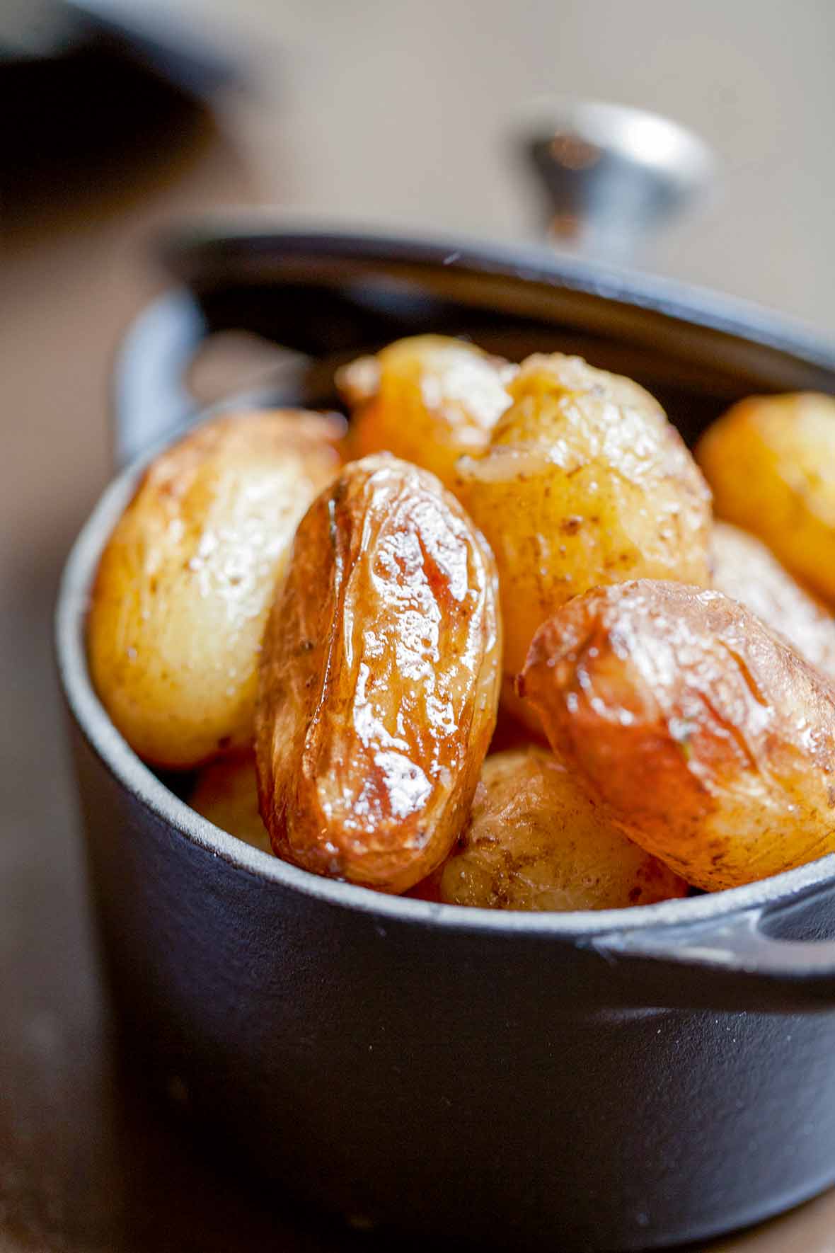 Cast iron pot with braised new potatoes inside