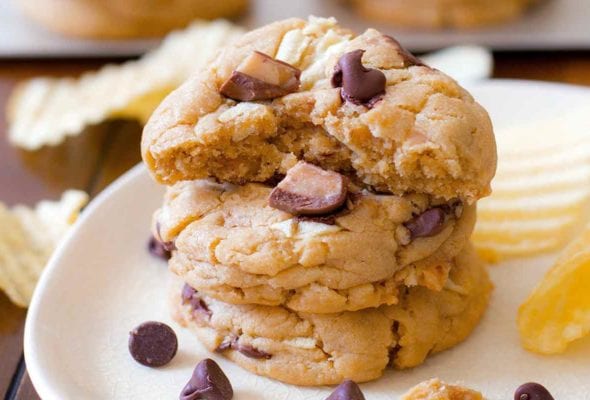 A plate of chocolate chip cookies with with potato chips and toffee pieces baked in