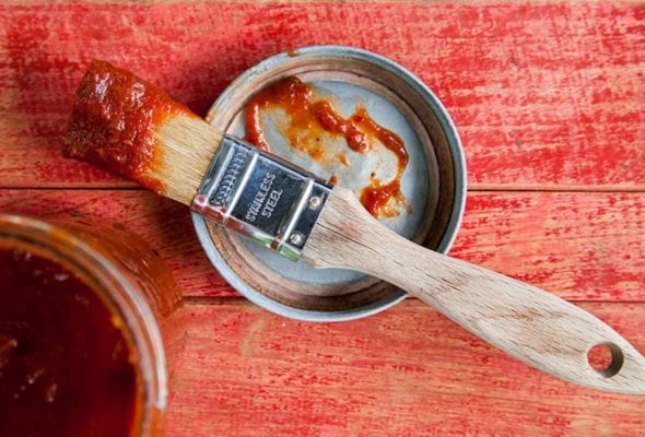 A basting brush with chipotle maple barbecue sauce