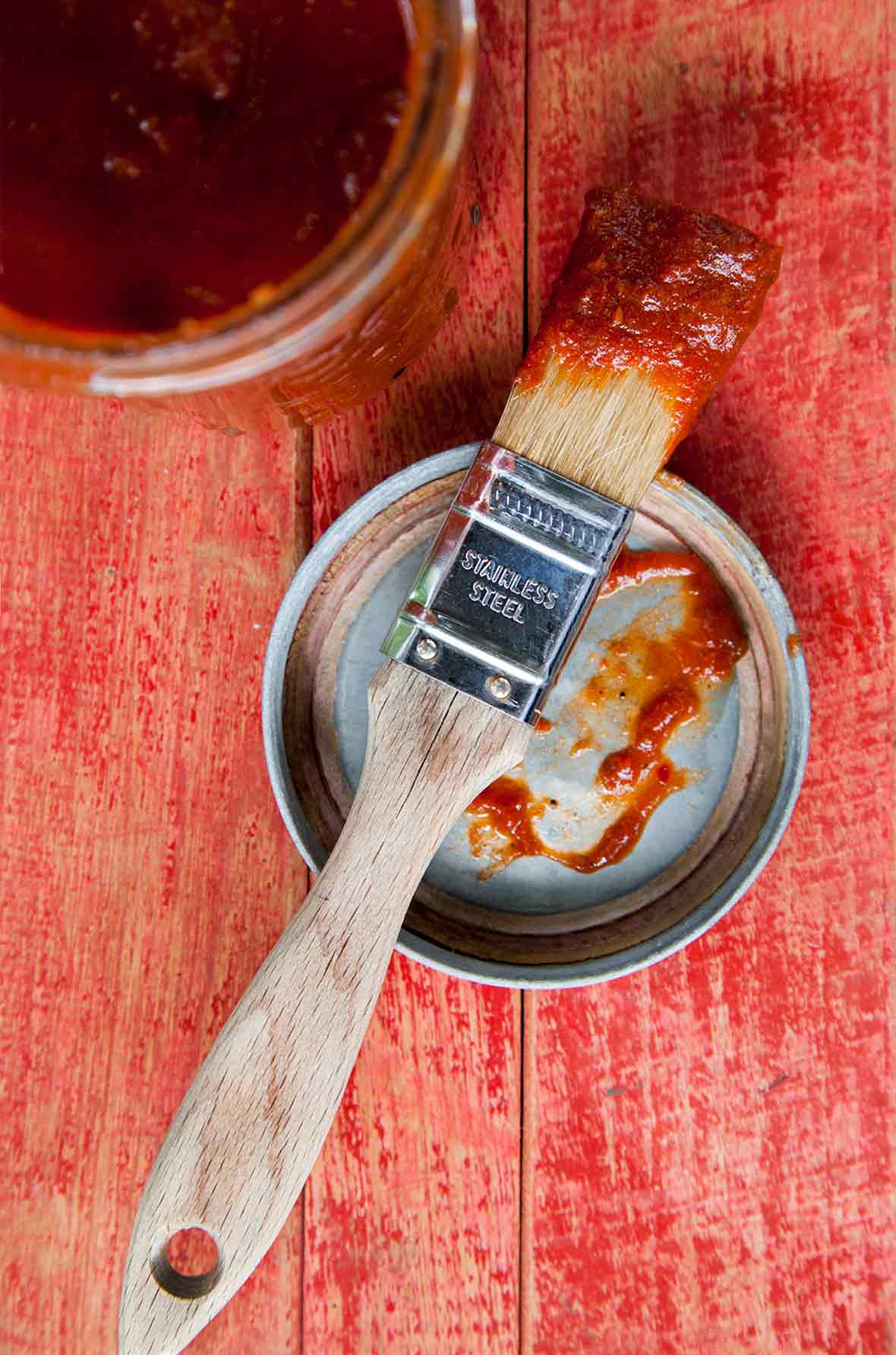 A basting brush with chipotle maple barbecue sauce
