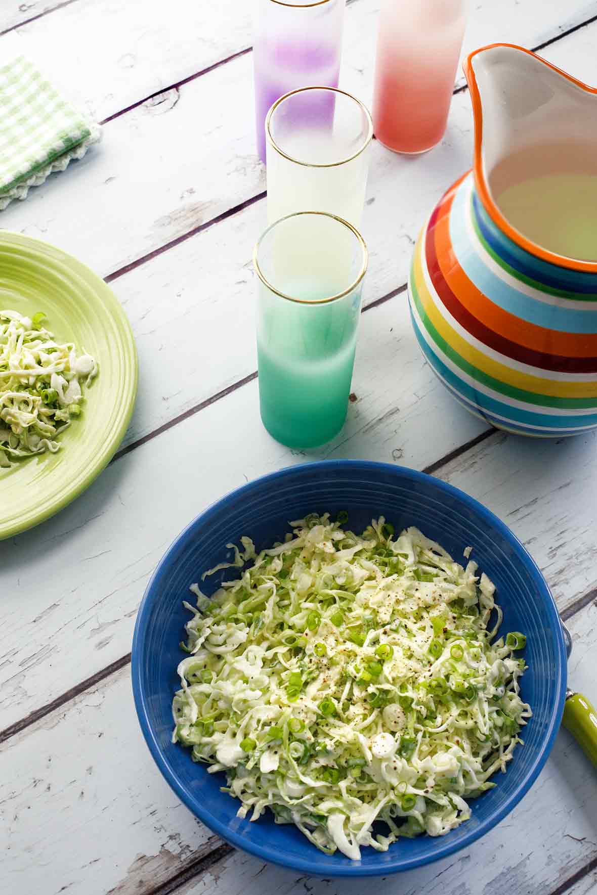 A blue ceramic bowl filled with classic coleslaw.