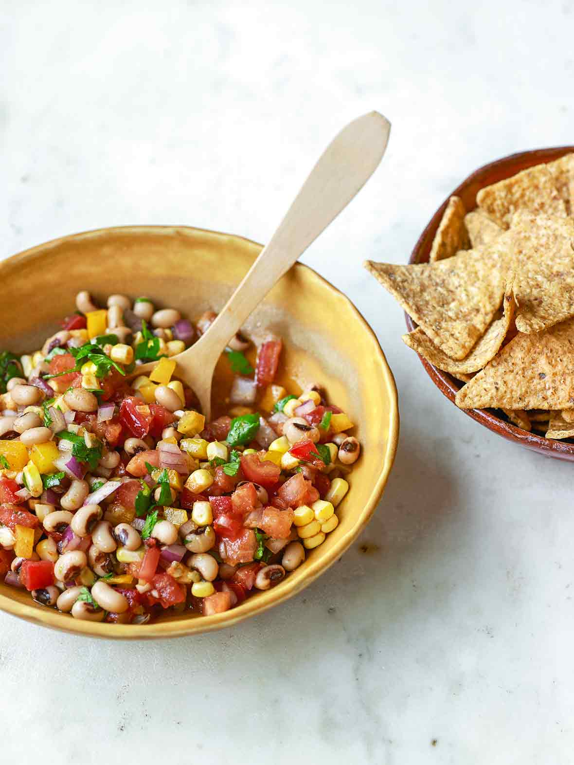 A yellow bowl of cowboy caviar--black-eyed peas, corn, red onion, tomato, red and yellow pepper by Dorie Greenspan