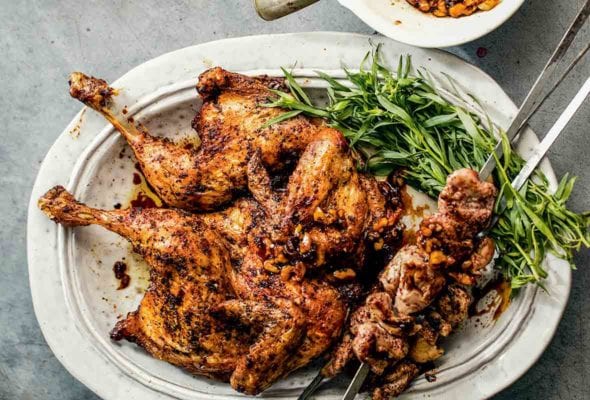 A platter of shish taouk or Middle Eastern grilled chicken and thighs slathered with a pomegranate-tamarind sauce