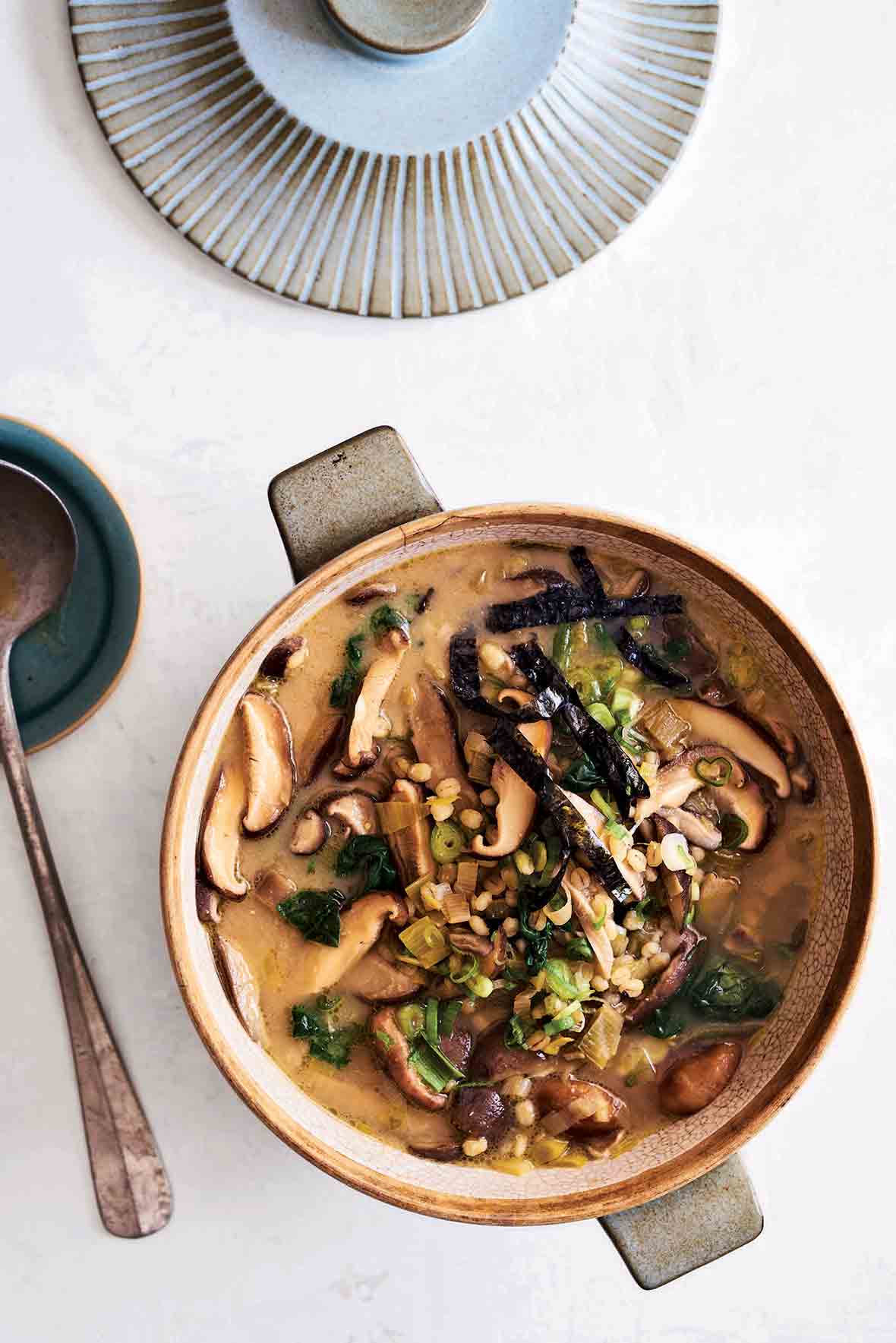 A crock filled with shiitake barley soup--mushroom, leeks, miso, ginger, scallions, nori seaweed
