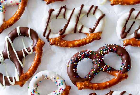 An assortment of chocolate covered pretzels with white and dark chocolate coating and sprinkles