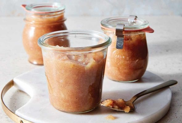 Three jars of slow cooker apple pear sauce on a white tray