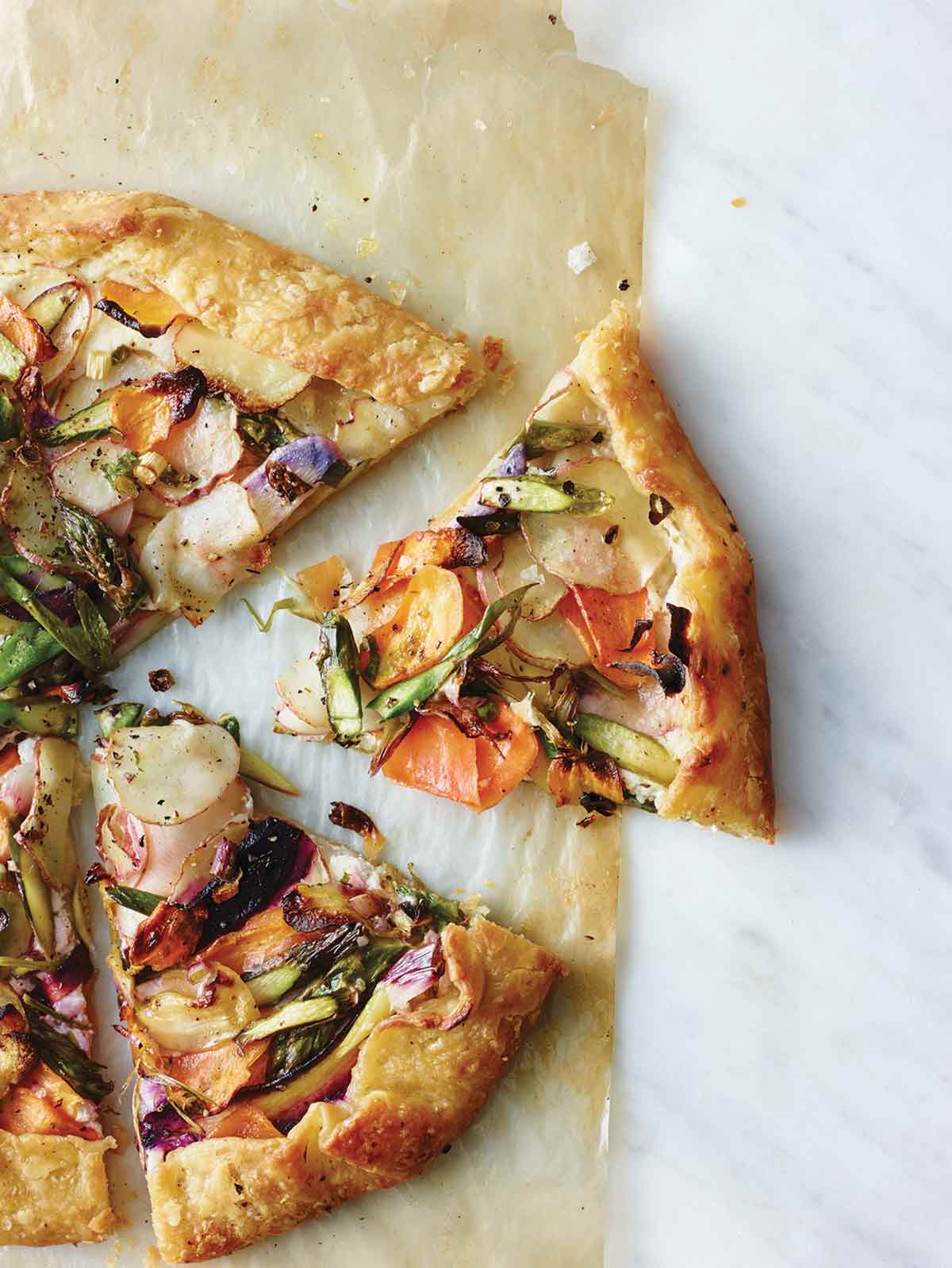 A round vegetable galette, with one slice cut out of it