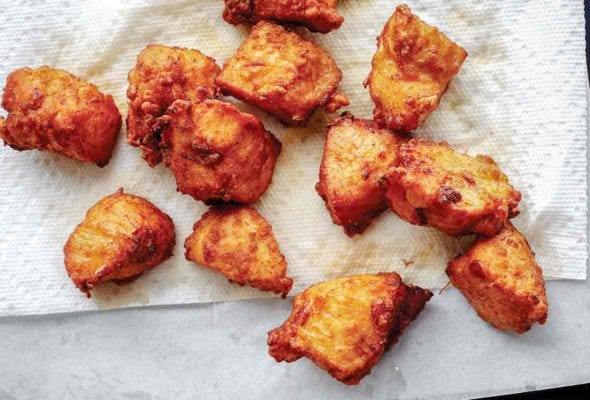 Several pieces of chicken karaage (Japanese fried chicken) draining on a paper towel
