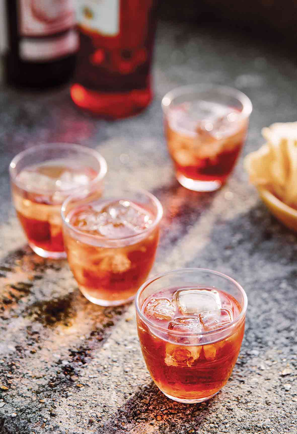 Four low ball glasses filled with pink sbagliato