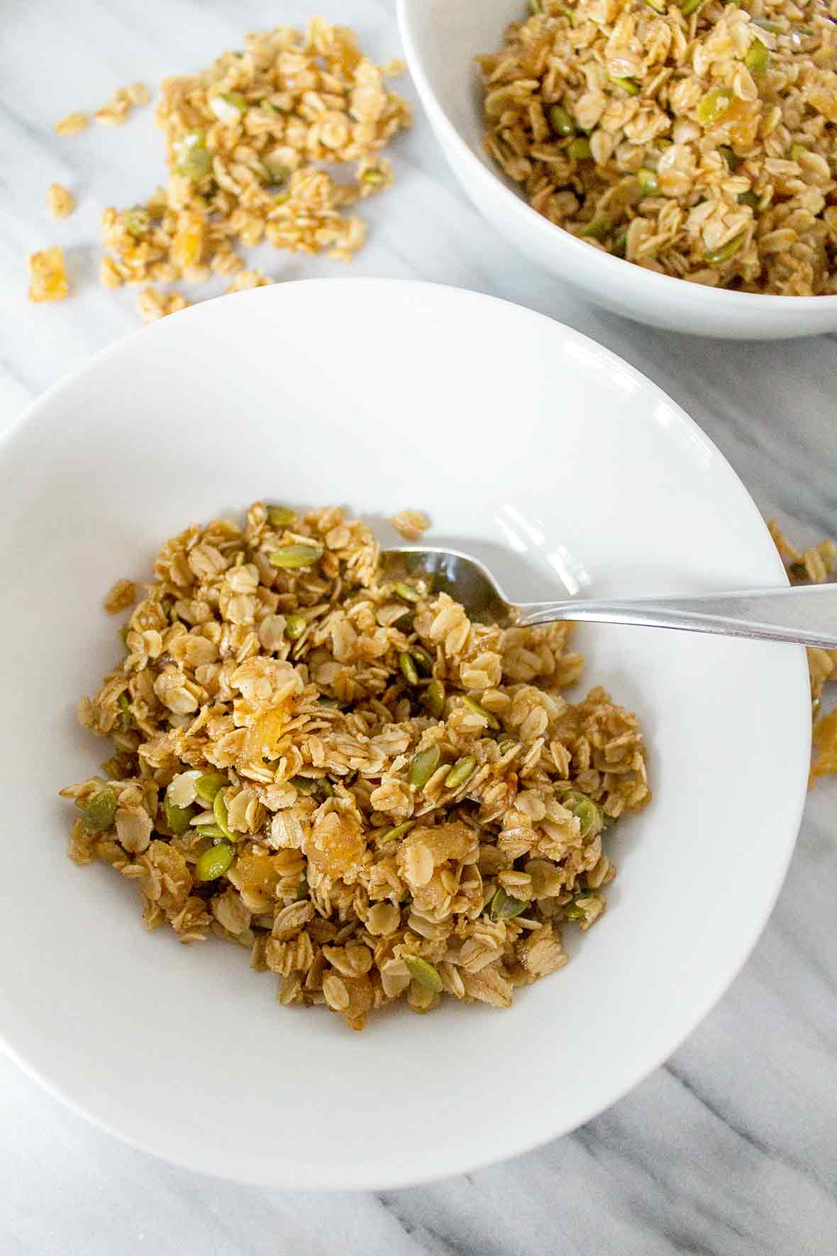 Two white bowls filled with soft ginger granola
